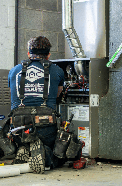 DMC technician doing a routine checkup on HVAC system