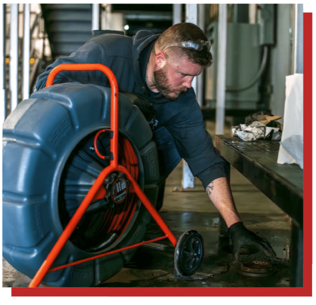 DMC technician working on clogged pipe flange